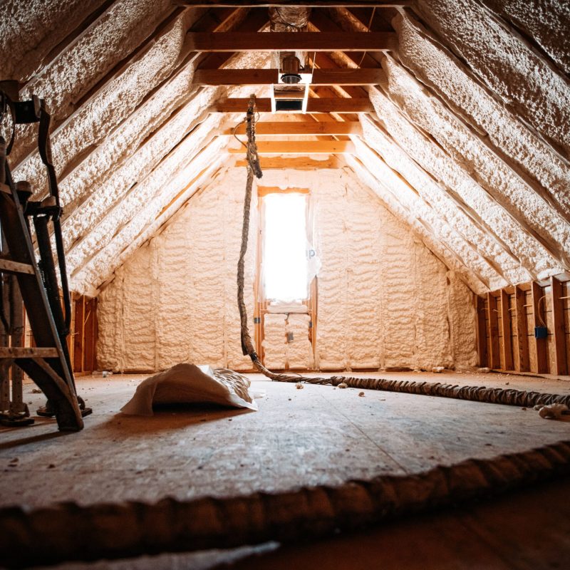An inside view of an attic covered with spray foam